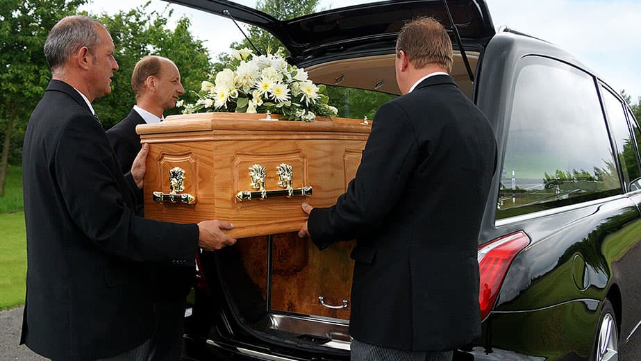 A UK funeral director consulting compassionately with a bereaved family
