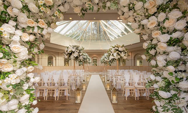 A wedding venue set up for an evening reception in the English countryside
